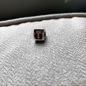 The “ T “ Pandora Charm